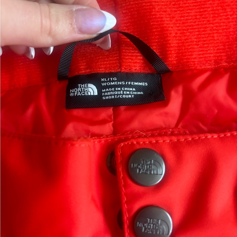 Red Orange North Face pants.